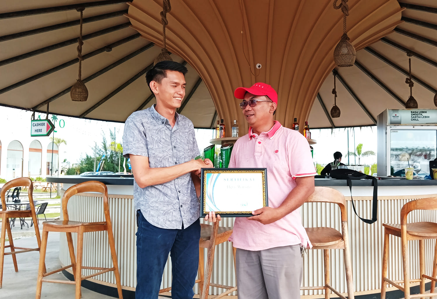 Candra P. Pusponegoro, CEO Yayasan An Nubuwwah Batam (kanan) saat menyerahkan sertifikat penghargaan kepada Hery Warsito, Manajer dan Penanggung Jawab Alio Beach Cafe and Bar di lokasi Alio, Bengkong Laut, Kecamatan Bengkong, Batam, Kepulauan Riau, Minggu (9/6/2024)